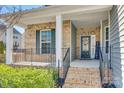Inviting front porch with brick steps, black railings, and a decorated front door at 2314 Talon Point Cir, Fort Mill, SC 29715