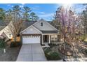 Beautiful brick home with a two-car garage, complemented by mature trees at 2439 Bergamot St, Fort Mill, SC 29708