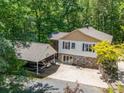 This house has a two-car carport, a big driveway that includes a basketball hoop, a stone retaining wall, and lots of foliage at 2988 Parks Lafferty Rd, Concord, NC 28025