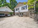 This house has a two-car carport, a big driveway that includes a basketball hoop, a stone retaining wall, and lots of foliage at 2988 Parks Lafferty Rd, Concord, NC 28025