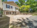 This house has a big driveway that includes a basketball hoop, a stone retaining wall, and lots of foliage at 2988 Parks Lafferty Rd, Concord, NC 28025