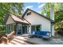 Charming home with a white brick exterior and a deck that adds outdoor living space with comfortable seating at 353 Whippoorwill Rd, Mooresville, NC 28117