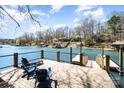 Inviting lakeside deck with Adirondack chairs offering stunning views and easy access to the water at 353 Whippoorwill Rd, Mooresville, NC 28117