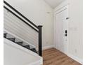A modern stairway with horizontal metal railings lead to a freshly painted front door and entrance at 4053 Crestview Dr, Rock Hill, SC 29732