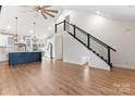 Bright living room with modern staircase and open floor plan flowing into a stylish kitchen with an island at 4053 Crestview Dr, Rock Hill, SC 29732