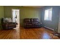 Comfortable living room featuring hardwood floors and plush brown leather seating at 4343 Saluda Rd, Rock Hill, SC 29730
