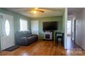 Inviting living room with hardwood floors, a decorative fireplace, and a comfortable leather sofa at 4343 Saluda Rd, Rock Hill, SC 29730