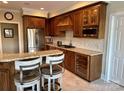 Gourmet kitchen with custom cabinets, granite countertops, stainless steel appliances, and wine fridge at 4687 Eagle Pointe Ct, Denver, NC 28037