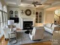 Inviting living room featuring a fireplace, built-in shelves, and neutral decor at 4687 Eagle Pointe Ct, Denver, NC 28037