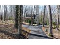 Traditional home on a wooded lot with a paved driveway at 608 Bubbling Well Rd, Matthews, NC 28105