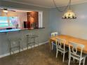 Dining room features tile floors and a counter/bar area looking into another living space at 7107 Wilson Grove Rd, Mint Hill, NC 28227