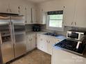 Bright kitchen featuring stainless steel appliances, white cabinetry, and a window bringing natural light at 7107 Wilson Grove Rd, Mint Hill, NC 28227