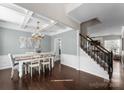 Elegant dining room featuring hardwood floors, coffered ceilings, and stylish chandelier at 7720 Dinniston Dr, Huntersville, NC 28078