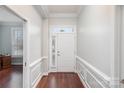 Inviting home foyer featuring hardwood floors, decorative molding, and a bright front door with transom window at 786 Platinum Dr, Fort Mill, SC 29708