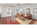 Cozy living room with hardwood floors, neutral walls, ceiling fan and a large window, providing ample natural light at 786 Platinum Dr, Fort Mill, SC 29708