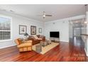 Comfortable living room featuring a ceiling fan, hardwood floors, and a view of the foyer from the open layout at 786 Platinum Dr, Fort Mill, SC 29708