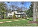 Charming two-story home with a landscaped yard and a brick walkway leading to the front door at 830 Jefferson Dr, Charlotte, NC 28270