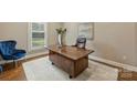 Well-lit office space with hardwood desk, plush chair, and neutral decor for a professional atmosphere at 830 Jefferson Dr, Charlotte, NC 28270