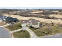 Aerial view of a home featuring a three-car garage, with golf course views and a manicured lawn at 103 Caddies Ct, Shelby, NC 28150