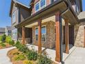 Inviting exterior elevation with covered front porch, stone accents, and well-maintained landscaping at 1030 Rolling Meadows Dr # Rm13, Mooresville, NC 28115