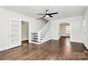 Cozy living room with hardwood floors, staircase, and access to other rooms through doorways and archways at 1101 Lancaster Ave, Monroe, NC 28112