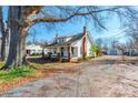 Well-maintained home with a garage and a beautiful lawn and mature trees in the surrounding yard at 112 Lentz St, Rockwell, NC 28138