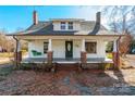 Inviting front porch with a classic porch swing on a charming older home with brick column bases at 112 Lentz St, Rockwell, NC 28138