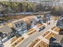 An aerial shot of a suburban neighborhood with well-maintained homes, landscaping, and tree-lined streets at 121 Edgehill Ct, Troutman, NC 28166