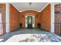 Inviting brick front entrance with elegant door, decorative accents, and manicured landscaping at 12702 Overlook Mountain Dr, Charlotte, NC 28216