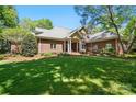 Beautiful brick home with lush green lawn, well-maintained landscaping, and a welcoming front entrance at 12702 Overlook Mountain Dr, Charlotte, NC 28216