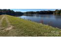 Green grassy bank leading to beautiful lake at 13828 Lake Bluff Dr, Matthews, NC 28105