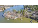 Stunning aerial view of a home on a lush private peninsula with a private dock at 2139 Peninsula Dr, Clover, SC 29710