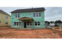 New home under construction with weather resistant wrap, windows installed, and covered back porch at 2216 Camber Dr # Cwo0074, Gastonia, NC 28054