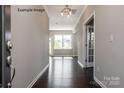 Inviting foyer with dark hardwood floors, neutral walls, crown molding, and a view into a sunlit living area at 2216 Camber Dr # Cwo0074, Gastonia, NC 28054