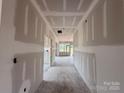 Long hallway under construction, featuring unfinished walls and a view towards a light-filled end at 2216 Camber Dr # Cwo0074, Gastonia, NC 28054