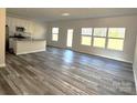 Open concept living room with wood floors and natural light at 224 Hillcrest Dr, Mooresville, NC 28115