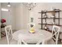 Charming dining area with farmhouse table, decorative shelving and view of front door at 2937 Bellasera Way, Matthews, NC 28105