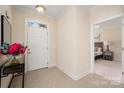 Inviting entryway featuring tile floors, a white front door, and view to bedroom at 2937 Bellasera Way, Matthews, NC 28105