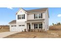 Charming two-story home with a two-car garage and a welcoming front porch at 418 Babbling Brook Ln # 245B, Locust, NC 28097