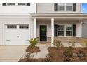 Close-up of the home's inviting front porch and a two-car garage at 418 Babbling Brook Ln # 245B, Locust, NC 28097