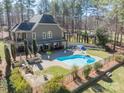 Aerial view of a backyard oasis with a pool, patio, and fenced yard at 4552 Sawgrass Ct, Denver, NC 28037