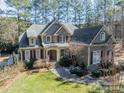 Beautiful two-story home featuring stone accents, red shutters and mature landscaping at 4552 Sawgrass Ct, Denver, NC 28037