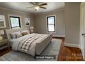 Bedroom featuring a neutral color palette, a bed with a patterned comforter and natural light from windows at 5135 Tucker Ave, Kannapolis, NC 28081
