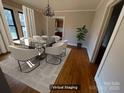 Virtual staging showcases a dining room with neutral color pallette and modern chandelier at 5135 Tucker Ave, Kannapolis, NC 28081