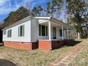 Charming single story home with brick foundation, green shutters, and covered front porch at 5135 Tucker Ave, Kannapolis, NC 28081