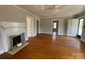 Bright living room featuring hardwood floors, fireplace, and doorways to other rooms of the house at 5135 Tucker Ave, Kannapolis, NC 28081