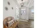 Bright foyer featuring hardwood floors, decorative lighting, and a charming bench at 702 Yucatan Dr, Waxhaw, NC 28173