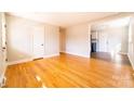 Bright living room features gleaming hardwood floors and neutral paint, perfect for relaxing or entertaining at 7231 Lockmont Dr, Charlotte, NC 28212