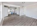 Spacious living room with new gray flooring and ample natural light, adjacent to a bright and modern kitchen at 801 Requa Rd, Cherryville, NC 28021