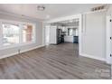 Bright and airy living room showcasing new gray flooring, seamlessly connecting to the modern kitchen at 801 Requa Rd, Cherryville, NC 28021